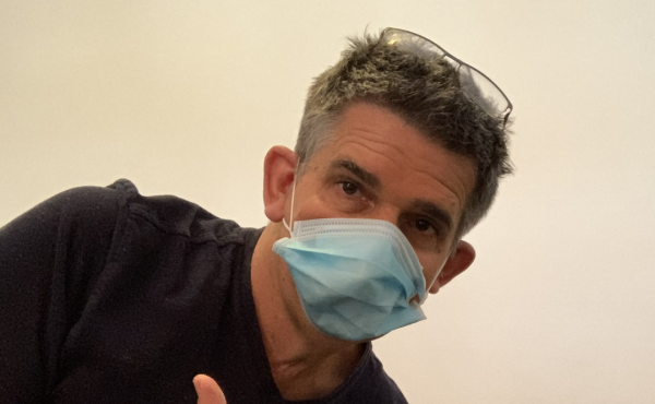 Jef wearing a mask, holding cleaning spray for Mask Policy Update